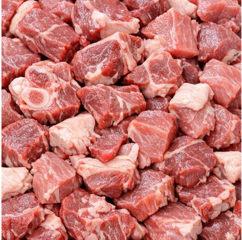 Close-up of cubed cuts of raw sheep and goat meat.